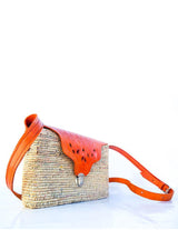 Handwoven leather and handwoven raffia shoulder bag with raffia